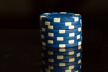 Blue playing poker chip isolated on Black background.