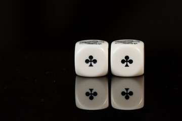 Casino playing poker dice two aces isolated on black background.
