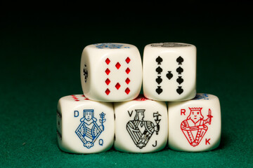 Playing poker dice straight closeup on green background