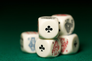 Playing poker dice straight closeup on green background