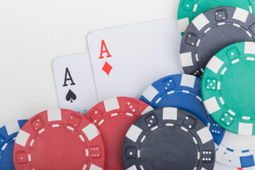 Pocket Aces, Hand Pair, Two Playing Cards and various color Poker Chips. Pattern Isolated on White Background.