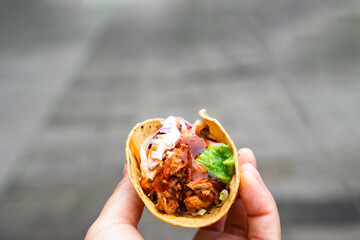 Mexican traditional authentic homemade tacos with pulled pork beef chili con carne serve with tomato salad and avocado guacamole and dip sauce