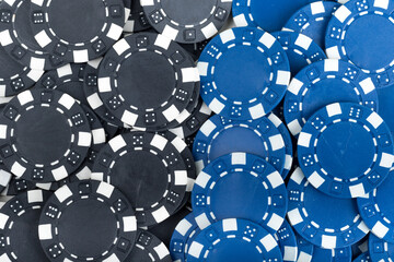 Battle Blue versus Black yin vs yang Playing Poker Chips laying on the table mixed together. Abstract Pattern Background 