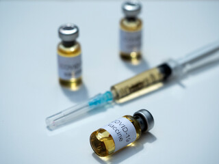 In this photo illustration, vials labelled as Coronavirus vaccine and a syringe seen displayed as the world anxiously awaits for the vaccine against coronavirus.