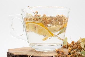 Herbal tea in a glass cup on a white background