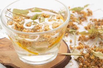 Herbal tea in a glass cup on a white background