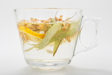 Herbal tea in a glass cup on a white background