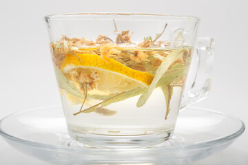 Herbal tea in a glass cup on a white background