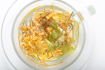 Herbal tea in a glass cup on a white background