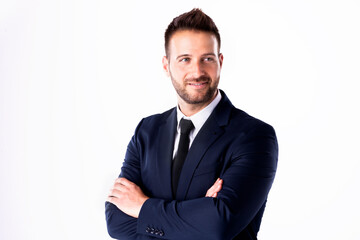 Studio shot of businessman standing with arms crossed at isolated white background