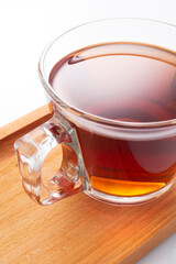 Black tea in a glass cup on a white background