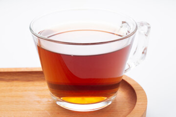 Black tea in a glass cup on a white background