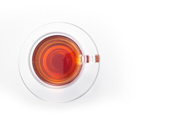 Black tea in a glass cup on a white background