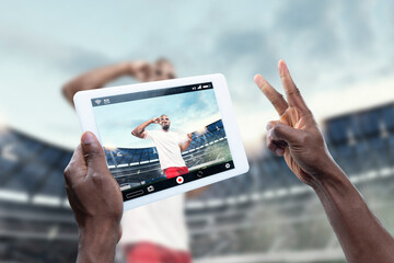 Close up hands holding tablet viewing sport, football online streaming of championship. New rules during coronavirus outbreak and countries lockdown. Concept of sport, competition, technologies.