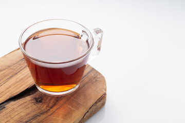 Black tea in a glass cup on a white background