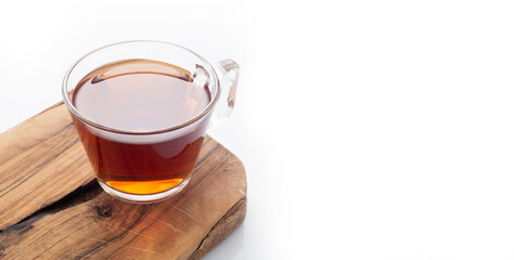 Black tea in a glass cup on a white background