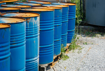 Big oil drums, blue. Chemical barrels in an open warehouse. Rusty barrels. Barrel for oil
