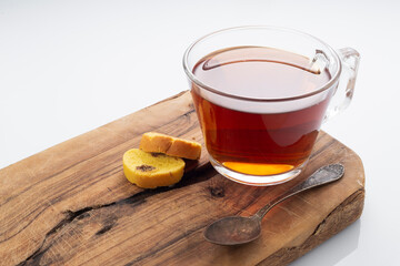 Black tea in a glass cup on a white background