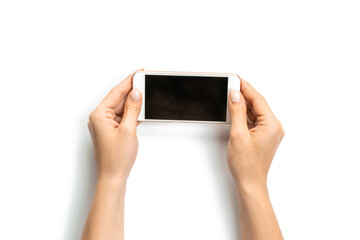 Cell phone hand. Cellphone with space for text. Woman holding smartphone in female hand with empty blank screen isolated on white background. Game play mobile concept.