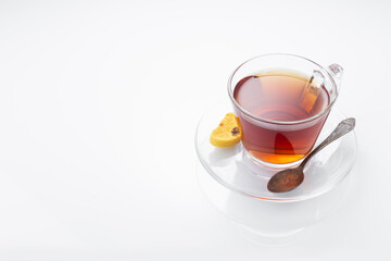 Black tea in a glass cup on a white background