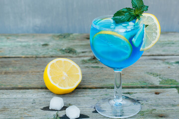 Cocktail with lemon slices, ice cubes and mint.