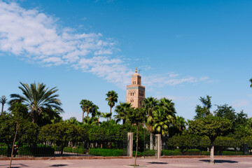 Fototapeta na wymiar Square and garden with the tower of the Moulay el Yazid Mosque mosque in the background