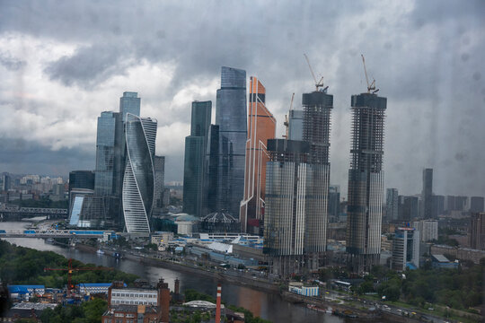 Fototapeta a view of a big city through the window where you can see that it is raining outside