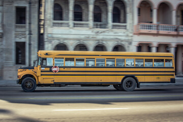 Naklejka na ściany i meble La Habana, Cuba; August 15, 2016: Typical USA yellow school bus in the street, this is international model 3800 / S1700