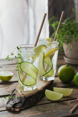 Glass of cucumber soda drink on wooden table. Summer healthy detox infused water, lemonade or cocktail background. Low alcohol, nonalcoholic drinks, vegetarian or healthy diet concept