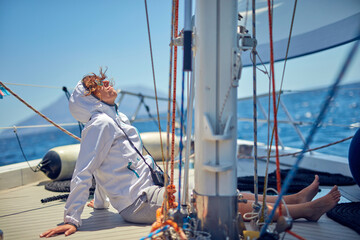 Summertime cruising and enjoying on a sailing boat at open sea.