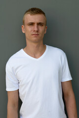 Obraz premium Portrait of young blond man against concrete wall outdoors