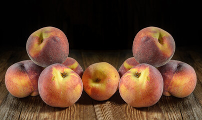 ripe peaches close-up on a dark wooden rustic background, horizontal view