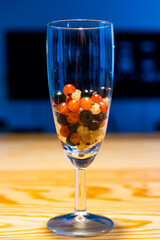 Glass with red currants, black currants and white transparent currants fruit cocktail