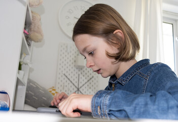 girl at home working on the tablet for school work