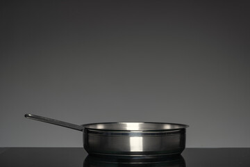 New cookware on black background, front view