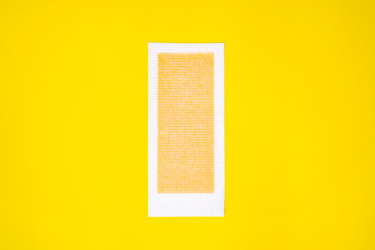 Wax streep for depilation on a bright yellow background