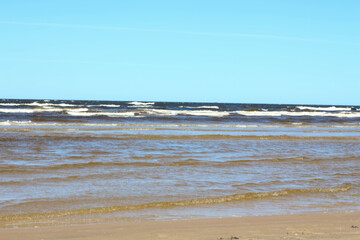 Coast of the Baltic Sea in Jurmala with white sand. Summer, spring relaxing on Sandy beach