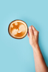 Top view of coffee in cup on blue background. Morning coffee time