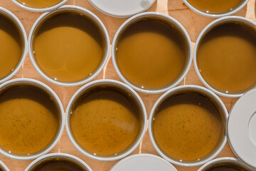 Production of marijuana medical salve with white gallipot and green leafs