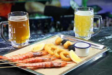 Beer pub. Langoustines and beer. Beer and seafood snacks. Langoustines, beer, squid rings. 