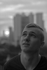 Portrait of young man with blond hair against view of the city