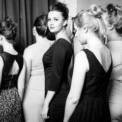 Plus size model get prepared to runway fashion show by make up artist. Black and white backstage concept