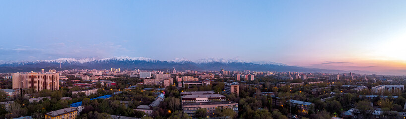 Panorama of the evening landscape of the city of Almaty with a view of the mountains