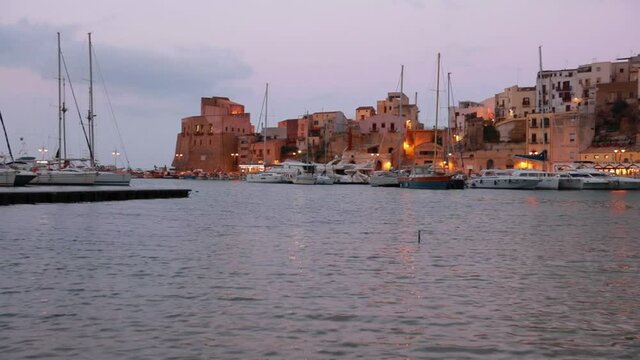 Splendid evening cityscape of Castellammare del Golfo port. Calm spring seascape of Mediterranean sea, Sicily, Italy. Full HD video (High Definition).