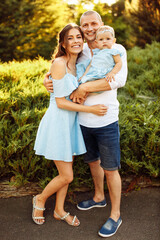Fototapeta premium Beautiful young family with little daughter