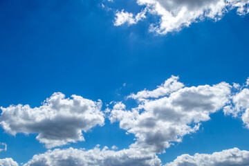 Naklejka na ściany i meble White and grey clouds on a blue sky