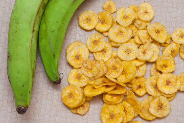 Kerala banana chips  popular deep fried snack traditional South Indian tea time snack on banana leaf, Kerala India. Frying chips in coconut oil on Onam, Vishu, Diwali/Deepawali, Ramzan, Eid. 