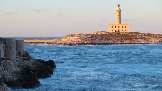 Stormy wether on Adriatic sea. Dramatic spring view of lighthouse in Vieste port, Italy, Europe. Full HD video (High Definition).

