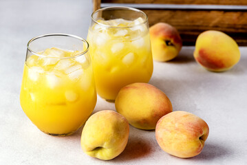 Ripe Peaches Tasty and Cold Peaches Juice Healthy Drink with Ice Cube Gray Background Horizontal