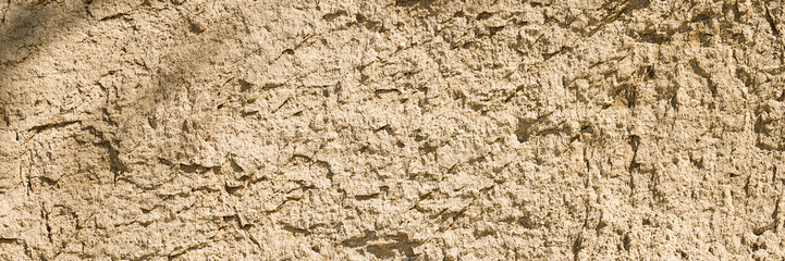 Background, a natural sandstone wall on a seaside cliff. Sandstone overlay